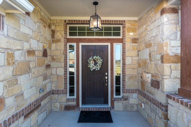 property entrance featuring stone siding and brick siding