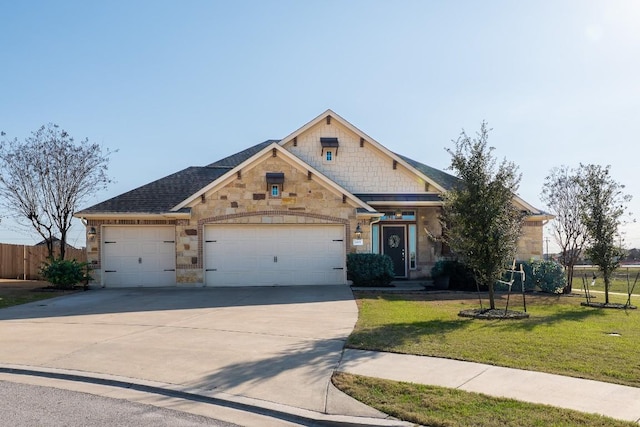 craftsman-style house featuring an attached garage, fence, driveway, stone siding, and a front lawn