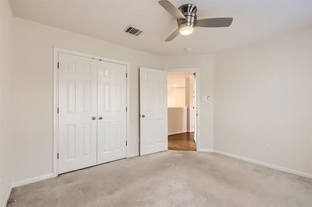 unfurnished bedroom featuring carpet, a closet, visible vents, and baseboards