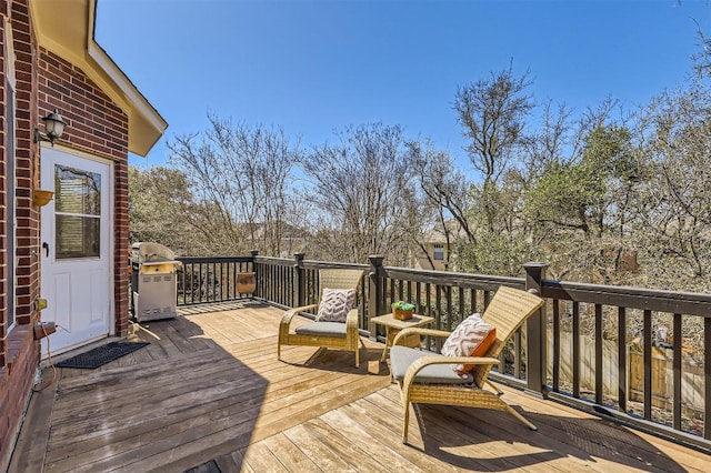 wooden deck with a grill