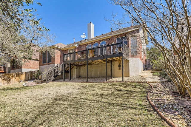 back of house with brick siding, fence, stairs, a lawn, and a chimney