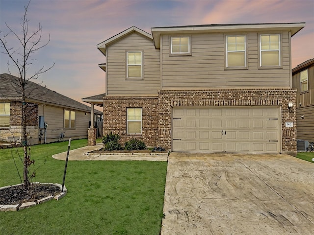 traditional home with brick siding, concrete driveway, a lawn, central AC unit, and a garage