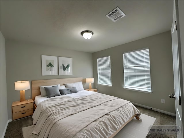 bedroom with carpet, baseboards, and visible vents