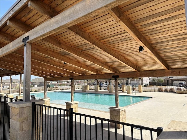 pool with fence and a patio