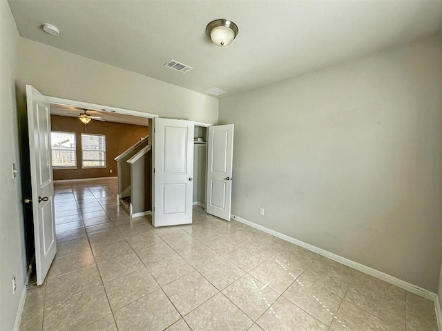 unfurnished room with light tile patterned floors, visible vents, and baseboards