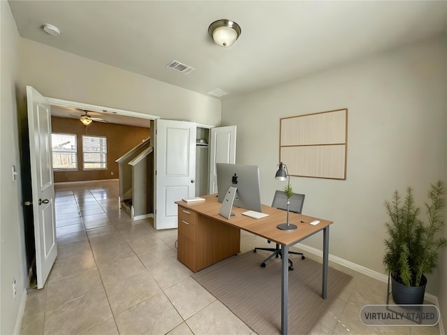 office featuring light tile patterned floors, baseboards, and visible vents