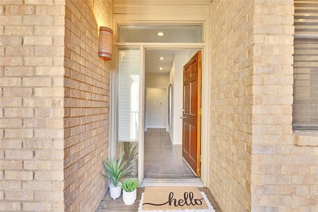 doorway to property with brick siding