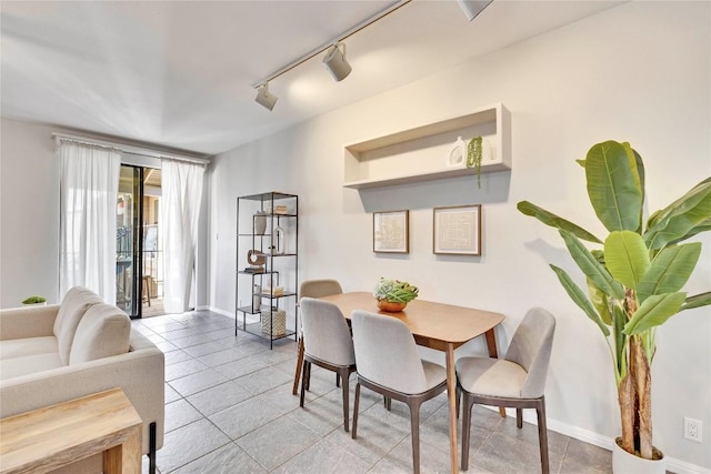 dining space with light tile patterned flooring and baseboards