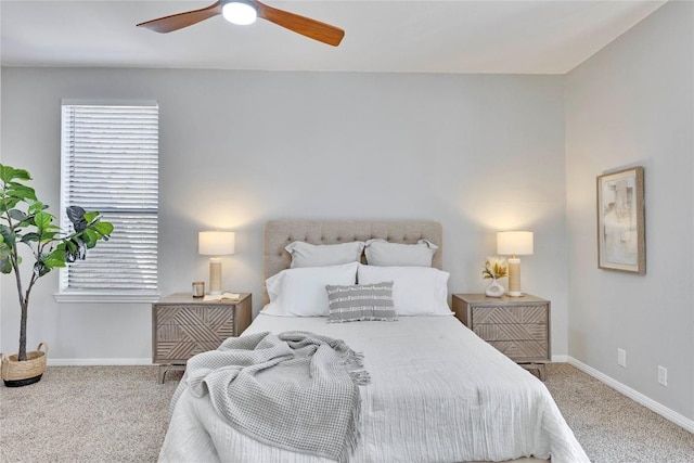 bedroom with a ceiling fan, baseboards, and carpet flooring