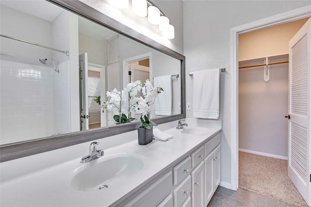 full bathroom featuring walk in shower, a sink, baseboards, and double vanity