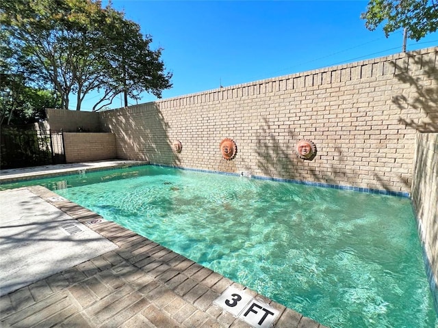 view of pool with a fenced in pool and fence