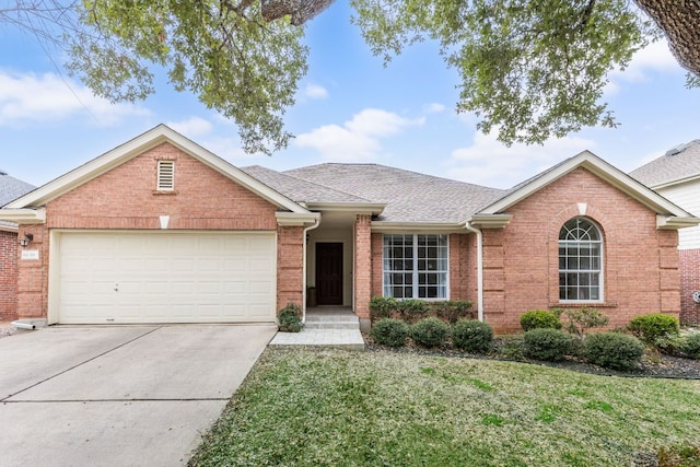 ranch-style house with concrete driveway, roof with shingles, an attached garage, a front lawn, and brick siding