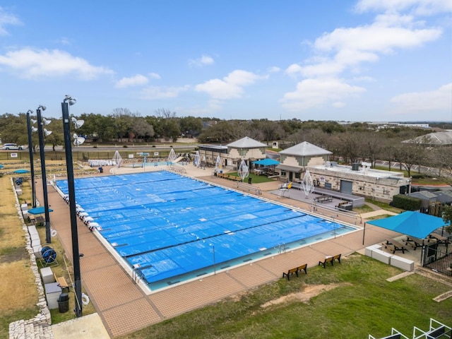 community pool with a patio and fence