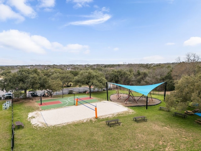 view of community featuring community basketball court, fence, and a yard