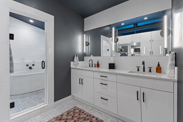 full bathroom featuring tile patterned flooring, a sink, a shower stall, and double vanity