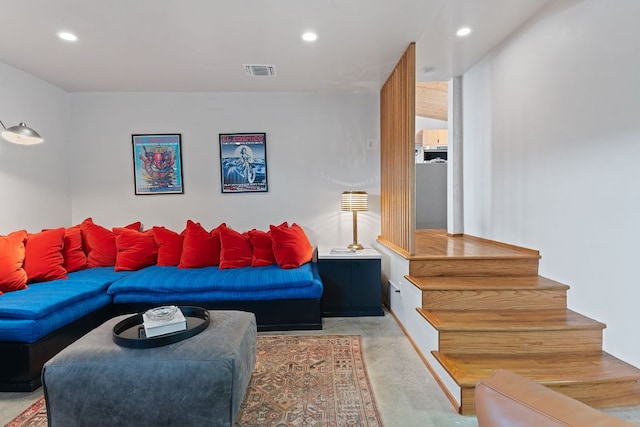 living area with stairs, visible vents, and recessed lighting