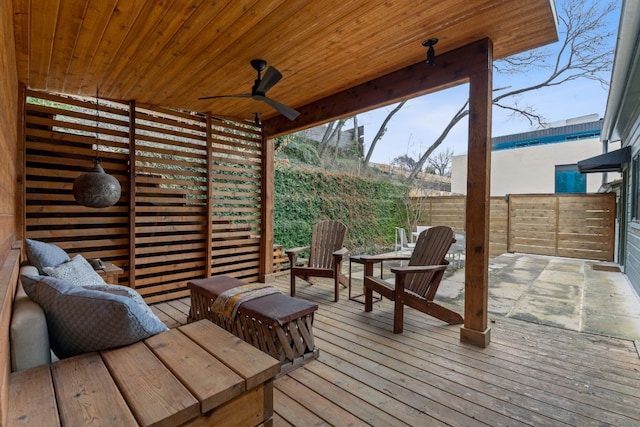 wooden terrace with fence and a ceiling fan