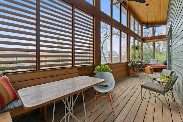 sunroom featuring wood ceiling and a ceiling fan