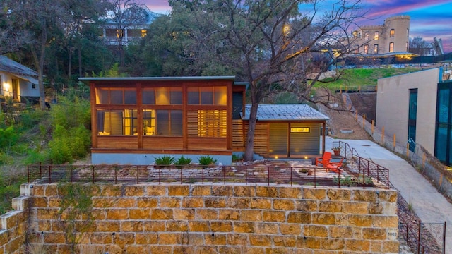 rear view of property featuring metal roof