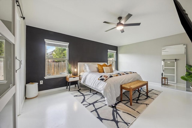 bedroom with a ceiling fan, baseboards, multiple windows, and finished concrete floors