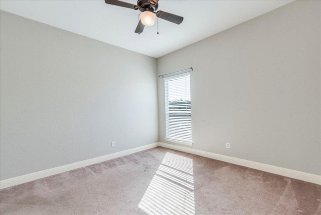 empty room with light carpet, ceiling fan, and baseboards