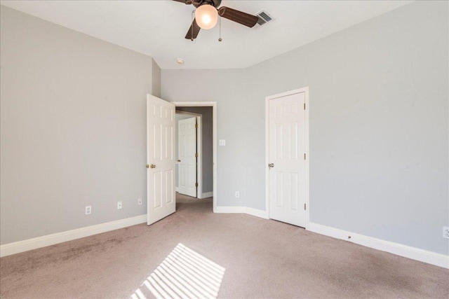 unfurnished bedroom featuring a ceiling fan, carpet flooring, visible vents, and baseboards