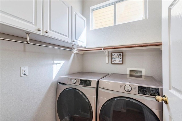 laundry room with cabinet space and washer and dryer