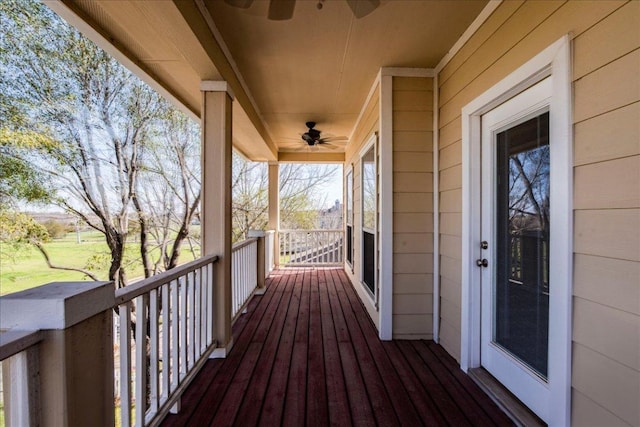 wooden terrace featuring ceiling fan