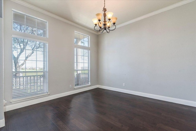 spare room featuring ornamental molding, dark wood finished floors, a notable chandelier, and baseboards