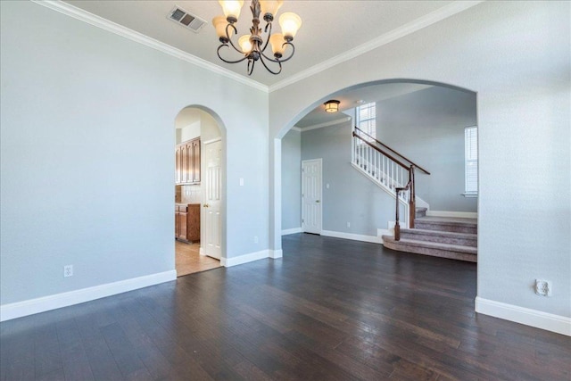 unfurnished room with wood finished floors, visible vents, and baseboards