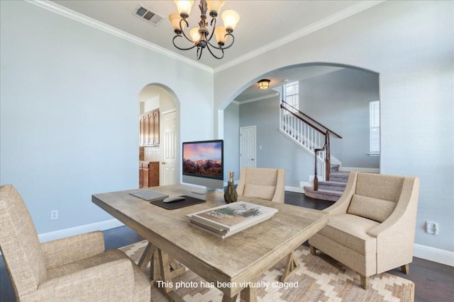 office space with crown molding, wood finished floors, visible vents, and baseboards