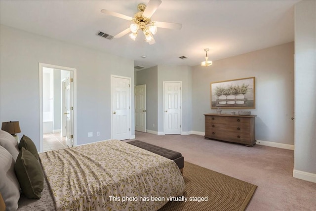 carpeted bedroom featuring baseboards, visible vents, a ceiling fan, and ensuite bathroom