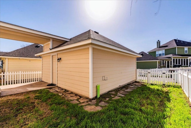 exterior space with fence and a lawn