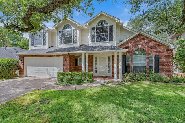 traditional-style home featuring a garage, a front yard, concrete driveway, and brick siding