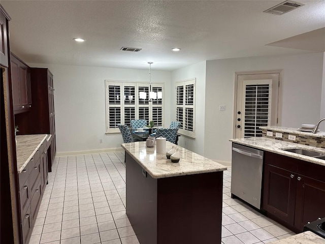 kitchen featuring a sink, a kitchen island, visible vents, and dishwasher