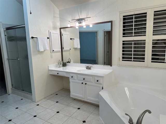 bathroom featuring a textured wall, a shower stall, vanity, a bath, and tile patterned floors