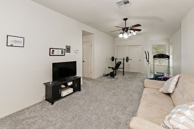 living room featuring a ceiling fan, baseboards, visible vents, and carpet flooring