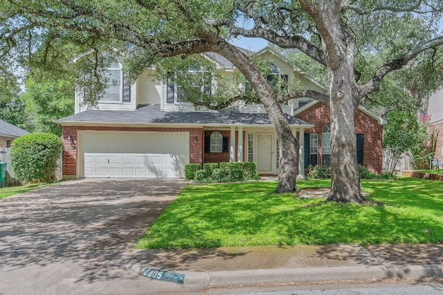 traditional-style house featuring a garage, brick siding, a shingled roof, concrete driveway, and a front lawn