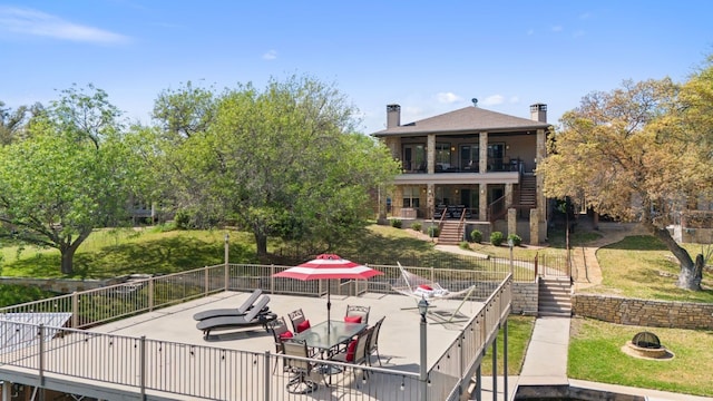 exterior space featuring an outdoor fire pit, a patio area, a yard, and stairway