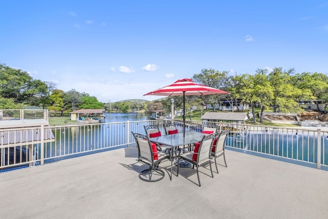 view of patio / terrace with outdoor dining area and a water view