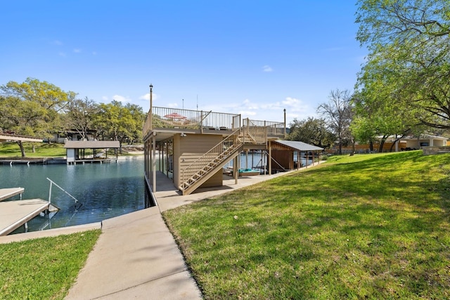 view of dock with a water view, a yard, and stairs