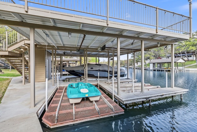 view of dock with stairs, a water view, and boat lift