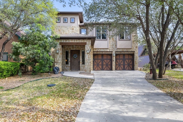 view of front facade with a garage, driveway, and stone siding