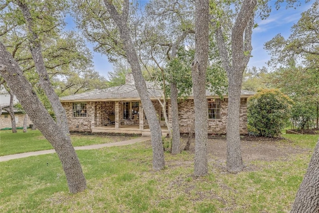 ranch-style home with a patio area, brick siding, and a front lawn