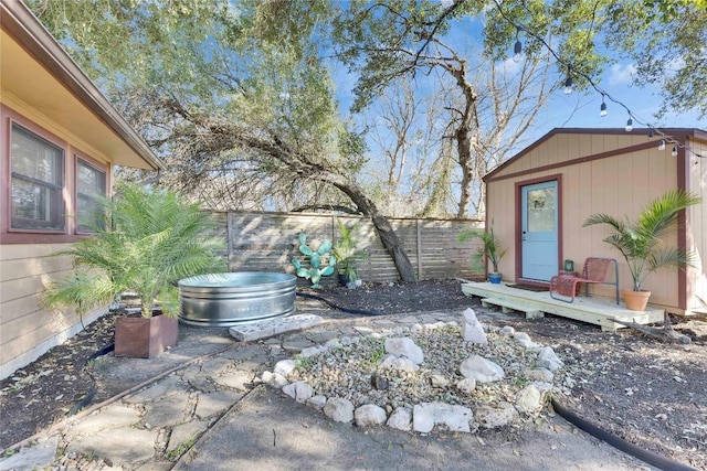 view of yard featuring a fenced backyard and an outbuilding