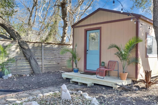 view of outbuilding with a fenced backyard and an outdoor structure