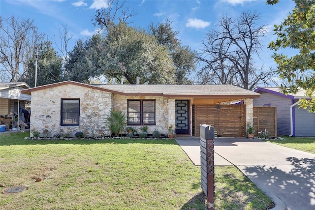 view of front facade featuring stone siding, driveway, and a front lawn