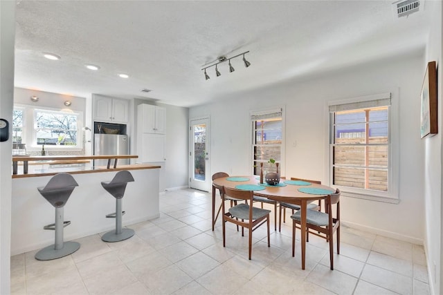 dining area featuring light tile patterned floors, baseboards, visible vents, a textured ceiling, and recessed lighting