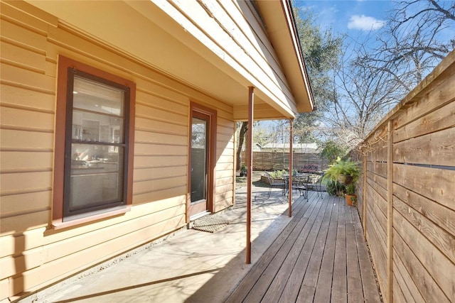 deck with a fenced backyard