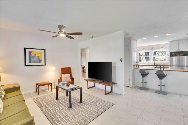 living room with light tile patterned floors, recessed lighting, visible vents, baseboards, and a ceiling fan